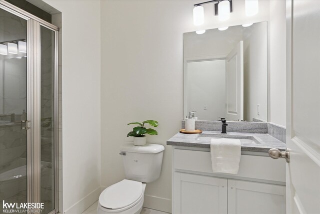 21168 Lilac Ln, Clinton Township, MI 48036 - bathroom with toilet, a shower stall, vanity, and baseboards