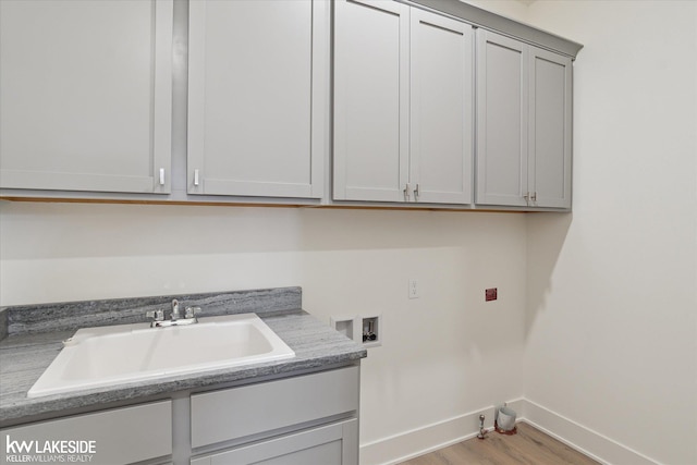 21168 Lilac Ln, Clinton Township, MI 48036 - laundry room with washer hookup, baseboards, cabinet space, and light wood-style flooring