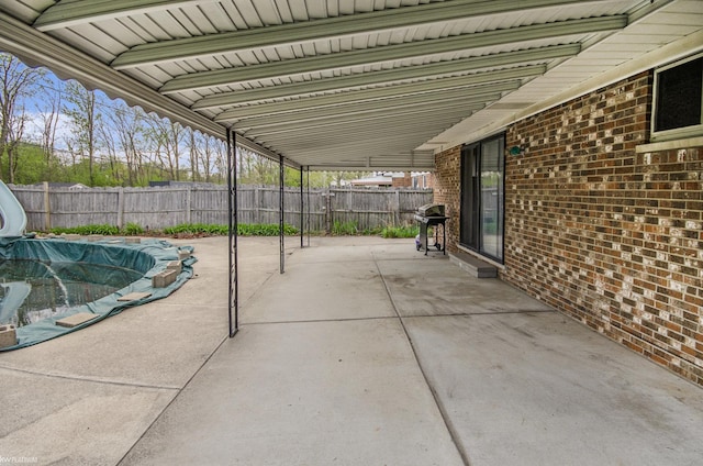 view of patio with a fenced backyard and a grill