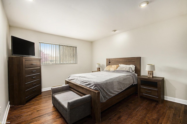 bedroom featuring dark wood-type flooring and baseboards