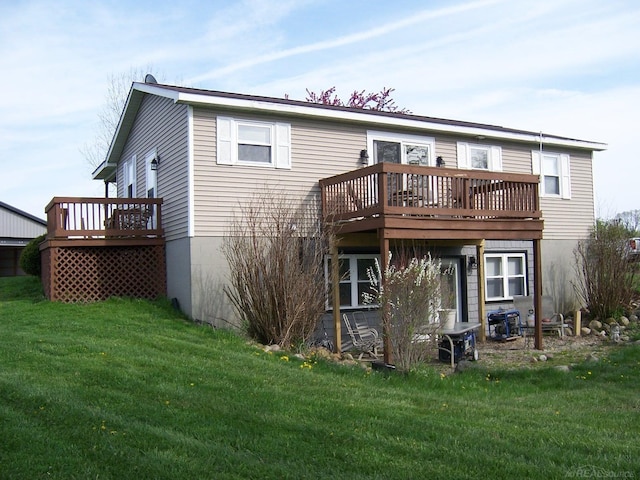 rear view of house with a deck and a yard