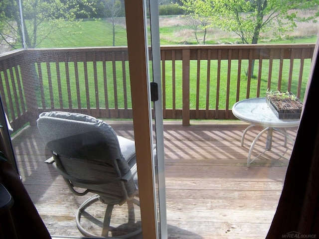 wooden terrace featuring a lawn