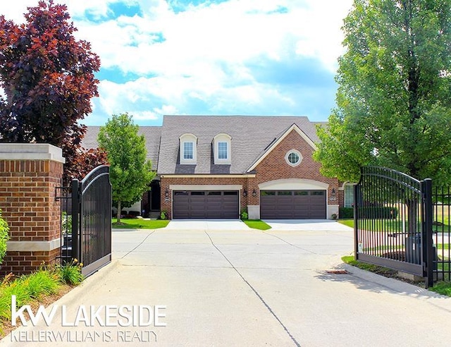 40699 Azalea Ln, Clinton Township, MI 48036 - view of front of home with a gate, concrete driveway, brick siding, and fence