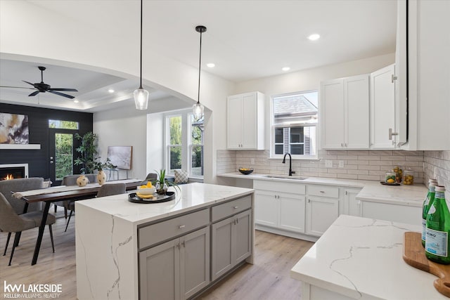 40699 Azalea Ln, Clinton Township, MI 48036 - kitchen featuring a sink, backsplash, open floor plan, light wood finished floors, and recessed lighting