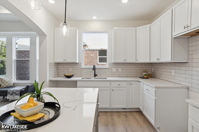 40699 Azalea Ln, Clinton Township, MI 48036 - kitchen with a sink, light stone countertops, light wood-style floors, white cabinetry, and recessed lighting