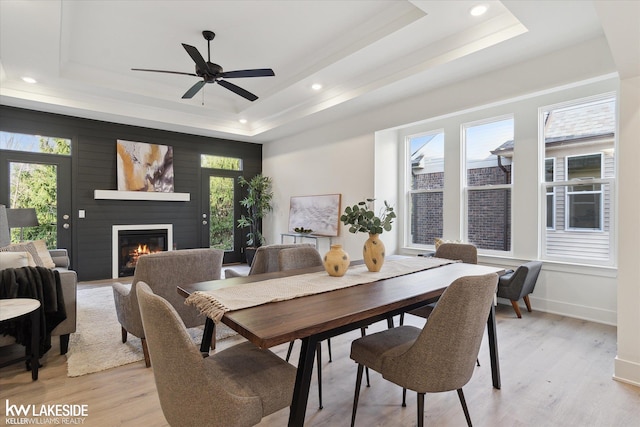 40699 Azalea Ln, Clinton Township, MI 48036 - dining space with a tray ceiling, light wood-style floors, healthy amount of natural light, recessed lighting, and a large fireplace