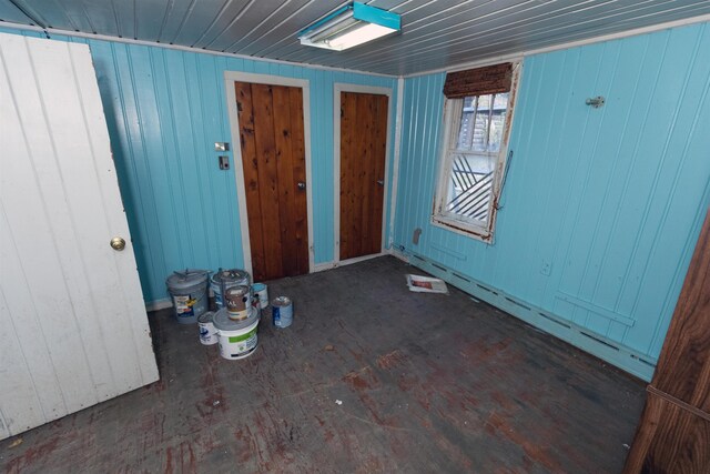 4440 W Cherry Creek Rd, Lewiston, MI 49756 - unfurnished room featuring wood walls and a baseboard heating unit