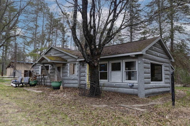 4440 W Cherry Creek Rd, Lewiston, MI 49756 - view of front facade with a shingled roof