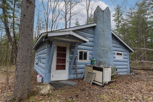 4440 W Cherry Creek Rd, Lewiston, MI 49756 - view of property exterior with a chimney