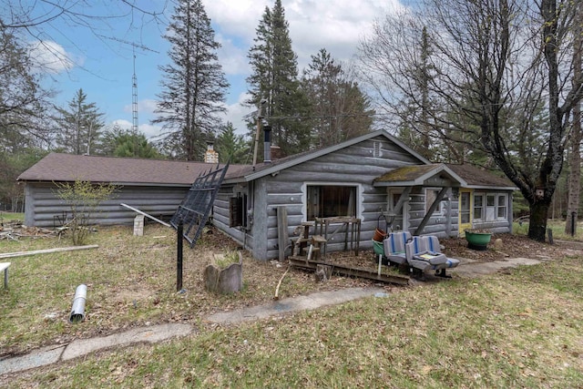 4440 W Cherry Creek Rd, Lewiston, MI 49756 - view of front facade featuring roof with shingles and a chimney