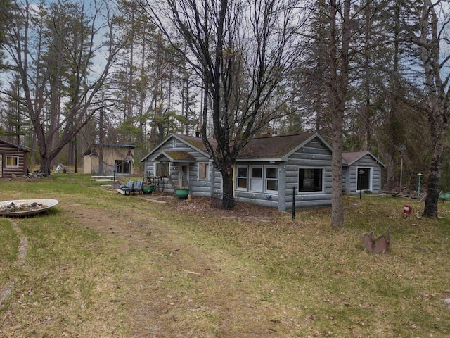 4440 W Cherry Creek Rd, Lewiston, MI 49756 - view of front facade featuring a front yard and a storage shed