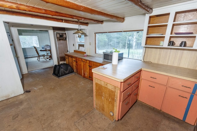 4440 W Cherry Creek Rd, Lewiston, MI 49756 - kitchen with a peninsula, light countertops, concrete flooring, healthy amount of natural light, and a wooden ceiling with exposed beams