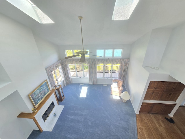 2707 Inverness Dr, Bay City, MI 48706 - living room featuring plenty of natural light, a ceiling fan, a skylight, and carpet floors