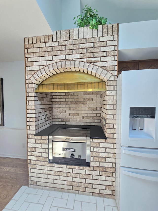 2707 Inverness Dr, Bay City, MI 48706 - detailed view of white refrigerator with ice dispenser and wood finished floors
