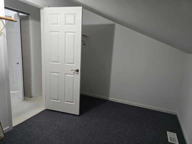 2707 Inverness Dr, Bay City, MI 48706 - additional living space with dark colored carpet and baseboards