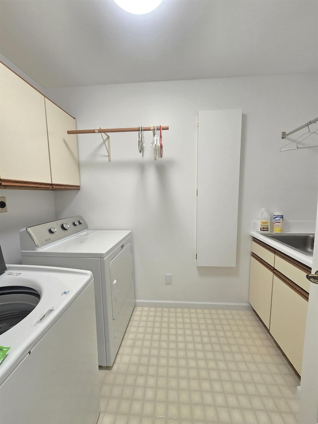 2707 Inverness Dr, Bay City, MI 48706 - laundry area featuring cabinet space, washer and dryer, light floors, and baseboards