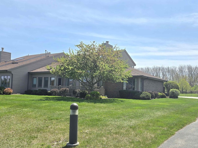 2707 Inverness Dr, Bay City, MI 48706 - view of front of property with a front yard and a chimney