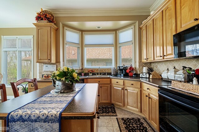 kitchen featuring black appliances, a sink, dark countertops, decorative backsplash, and crown molding