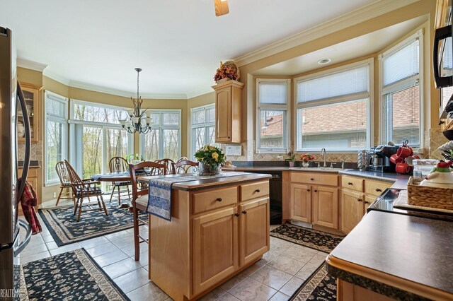 kitchen with freestanding refrigerator, a chandelier, a sink, ornamental molding, and black dishwasher
