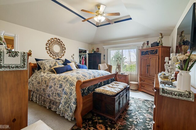 bedroom featuring a ceiling fan and lofted ceiling