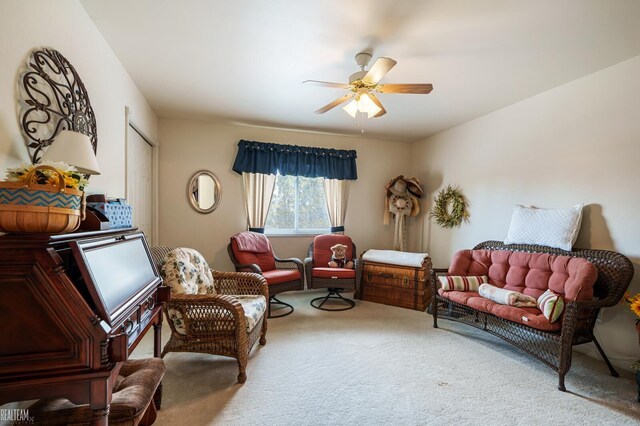 living area with carpet floors and a ceiling fan