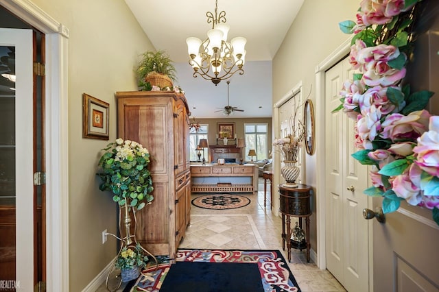 entrance foyer with a chandelier and a fireplace