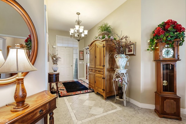 entrance foyer featuring a chandelier and baseboards