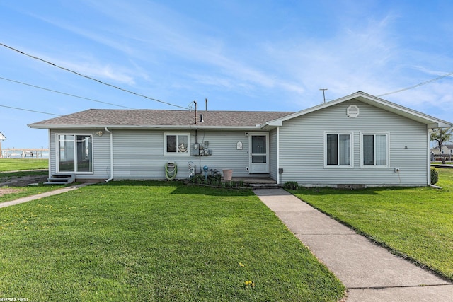single story home with a front lawn and roof with shingles