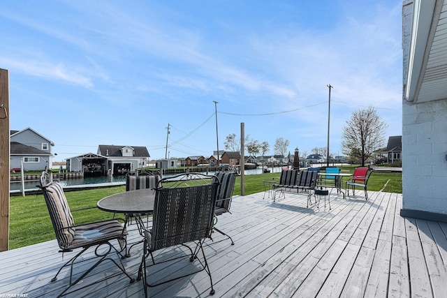 wooden terrace featuring a yard, a residential view, and a water view
