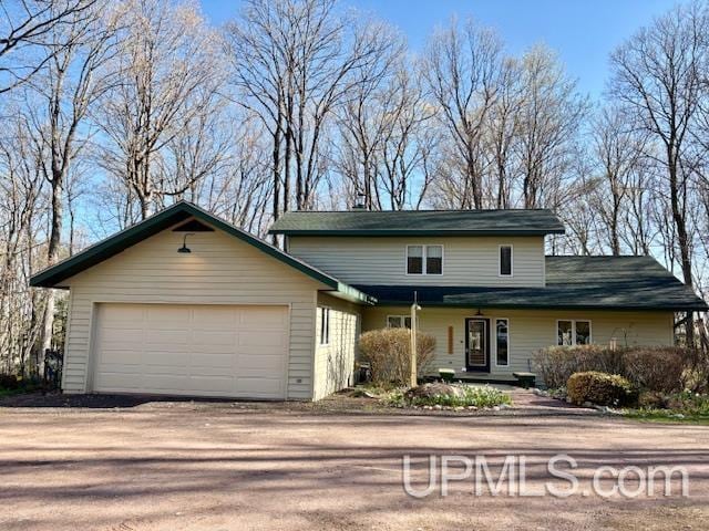 E5420 N Star Rd, Ironwood, MI 49938 - traditional-style home featuring a garage and driveway