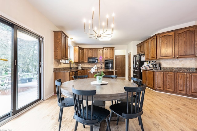 dining area featuring a chandelier and light wood finished floors