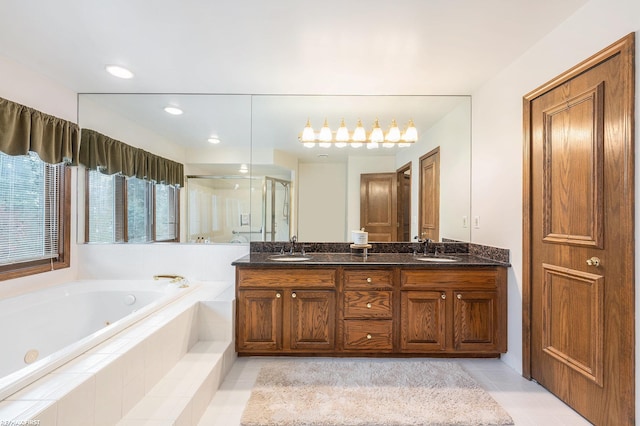 bathroom with a tub with jets, a shower stall, tile patterned flooring, double vanity, and recessed lighting