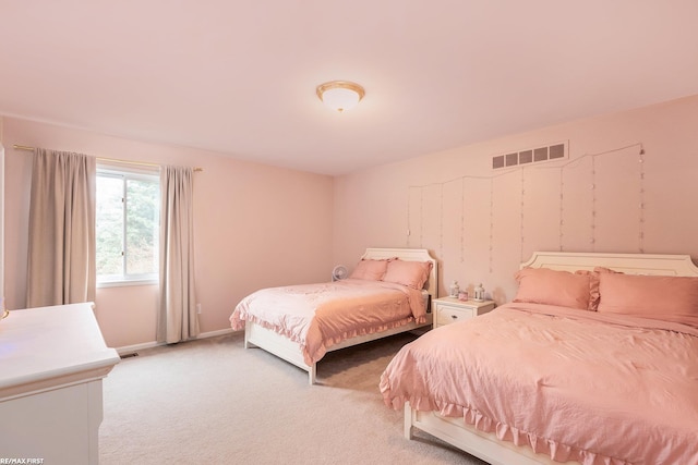bedroom featuring light colored carpet and baseboards