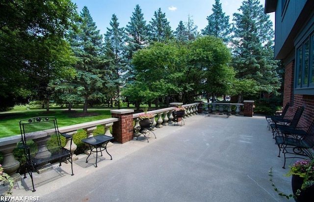 view of patio / terrace featuring view of wooded area