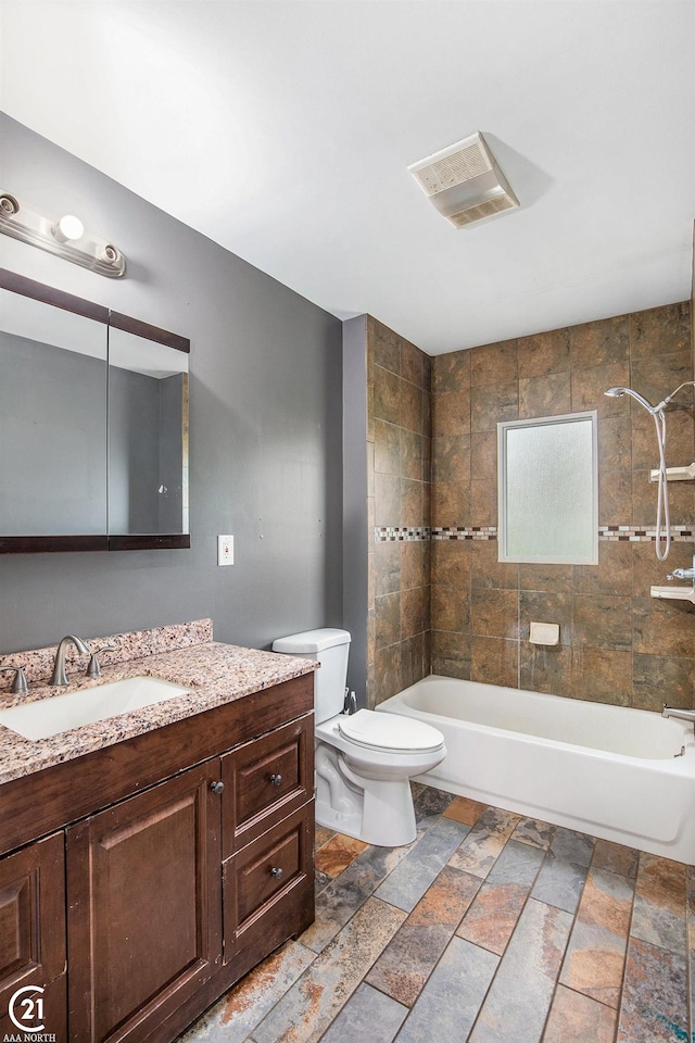 6424 Hunters Creek Rd, Imlay City, MI 48444 - full bath with toilet, stone tile floors, vanity, and shower / bathtub combination