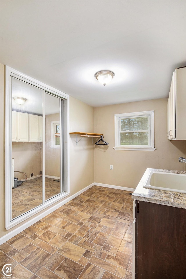 6424 Hunters Creek Rd, Imlay City, MI 48444 - washroom with cabinet space, plenty of natural light, and baseboards
