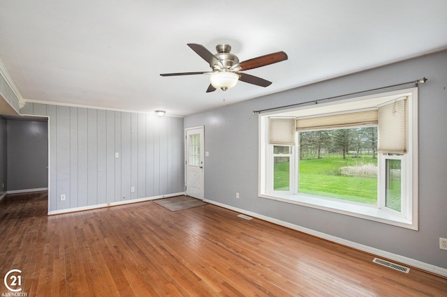 6424 Hunters Creek Rd, Imlay City, MI 48444 - empty room featuring baseboards, hardwood / wood-style floors, a ceiling fan, and healthy amount of natural light