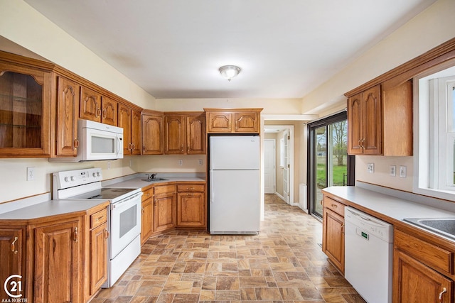 6424 Hunters Creek Rd, Imlay City, MI 48444 - kitchen featuring white appliances, brown cabinets, stone finish flooring, glass insert cabinets, and light countertops