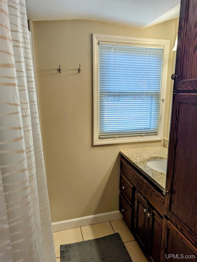 full bathroom featuring tile patterned floors, baseboards, vanity, and a shower with shower curtain