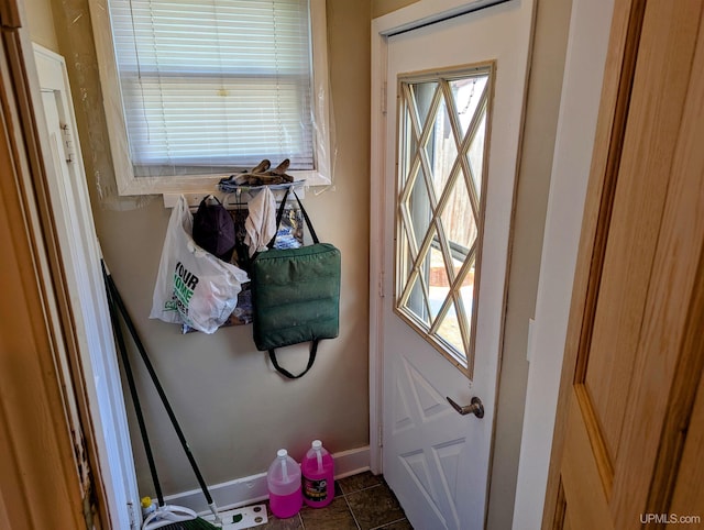 entryway with plenty of natural light, baseboards, and tile patterned flooring
