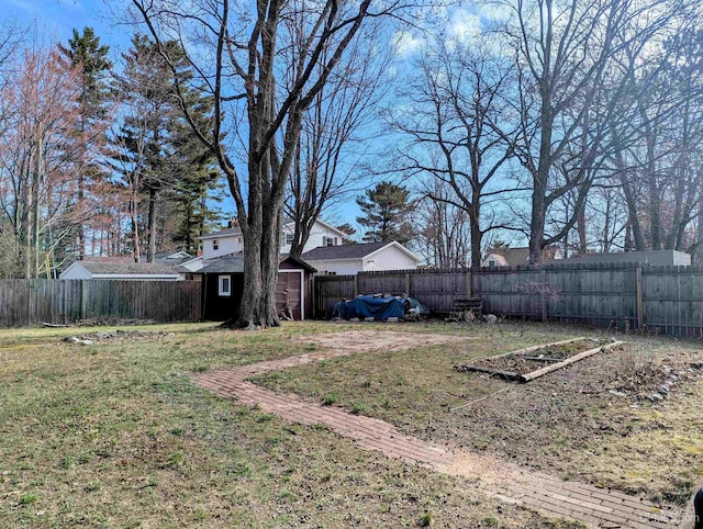 view of yard featuring an outbuilding and a storage shed