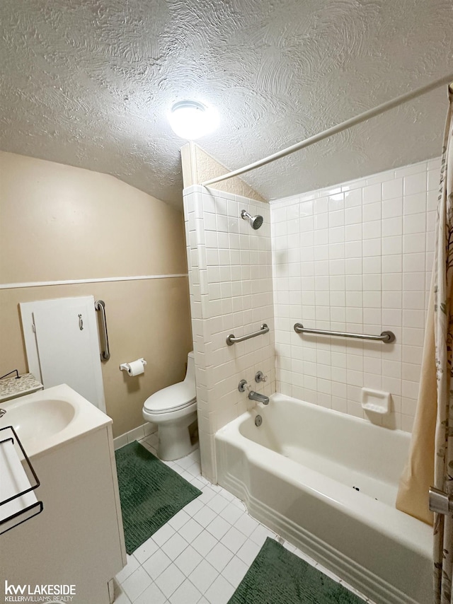 bathroom with toilet, tile patterned flooring, shower / bath combination with curtain, a textured ceiling, and vanity