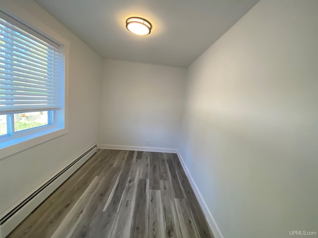 1005 W Brown St, Iron Mountain, MI 49801 - unfurnished room with a baseboard heating unit, wood finished floors, and baseboards