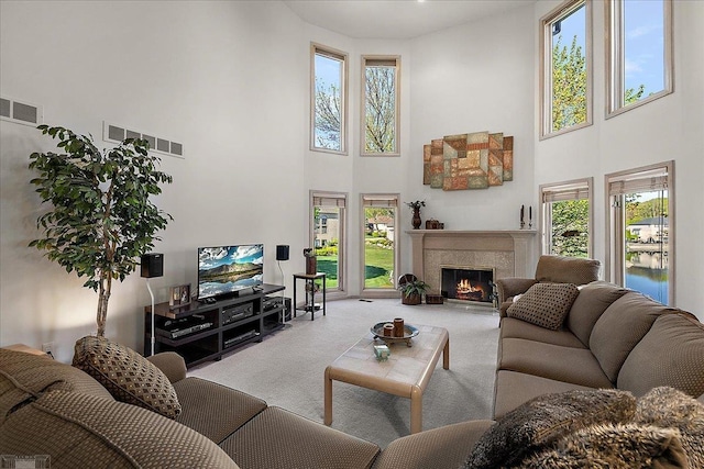 53633 Cherrywood Dr, Shelby Twp, MI 48315 - carpeted living area featuring a towering ceiling, plenty of natural light, and a premium fireplace