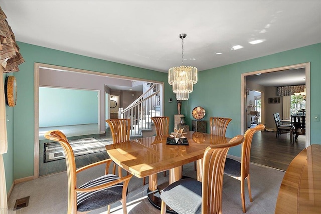 53633 Cherrywood Dr, Shelby Twp, MI 48315 - dining room featuring a chandelier, stairway, baseboards, and wood finished floors
