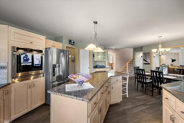 53633 Cherrywood Dr, Shelby Twp, MI 48315 - kitchen with appliances with stainless steel finishes, a center island, dark wood-style floors, a chandelier, and dark stone countertops