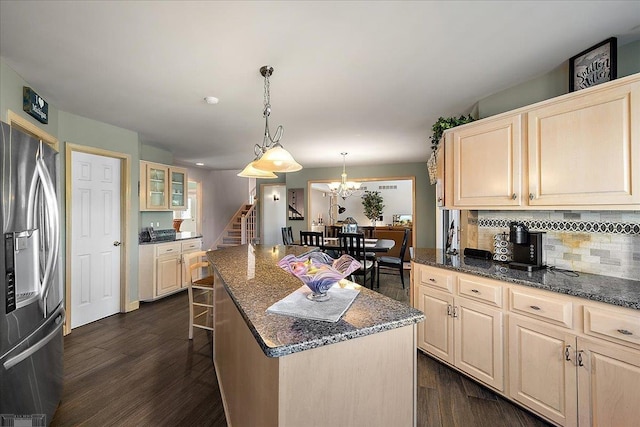 53633 Cherrywood Dr, Shelby Twp, MI 48315 - kitchen featuring stainless steel refrigerator with ice dispenser, tasteful backsplash, dark wood-style flooring, a kitchen island, and dark stone counters