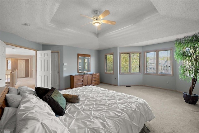 53633 Cherrywood Dr, Shelby Twp, MI 48315 - bedroom featuring a textured ceiling, light colored carpet, baseboards, ceiling fan, and a tray ceiling