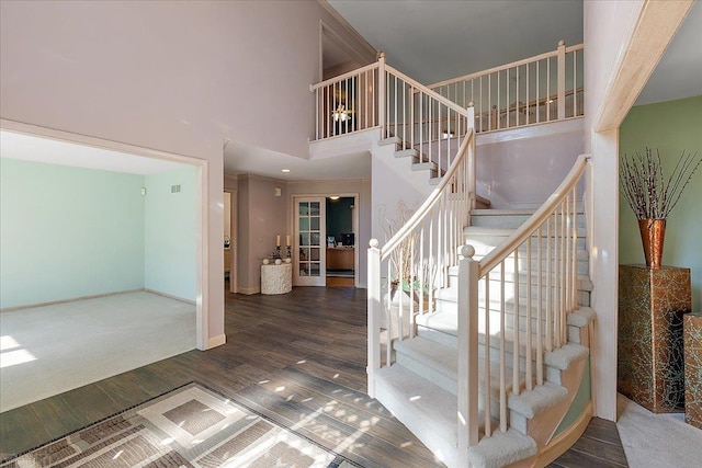53633 Cherrywood Dr, Shelby Twp, MI 48315 - stairway featuring a towering ceiling, wood finished floors, and baseboards