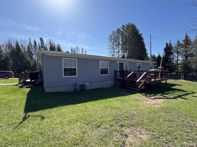 5278 27.5 Rd, Gladstone, MI 49837 - back of house with a deck, a lawn, cooling unit, and crawl space